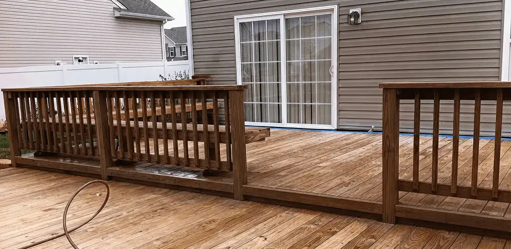 Deck sealing service protecting a backyard wood deck and railings in Albuquerque, NM