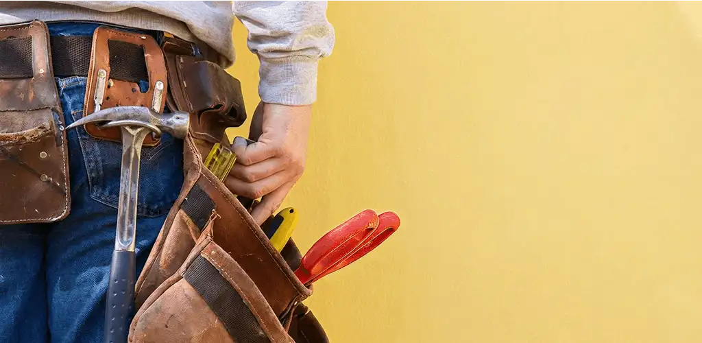 Handyman with tool belt ready for home repairs and maintenance in Albuquerque, NM
