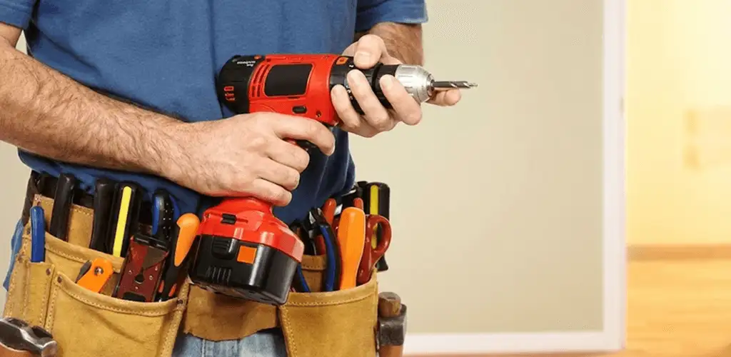 Handyman holding a power drill for home repairs and installations in Albuquerque, NM